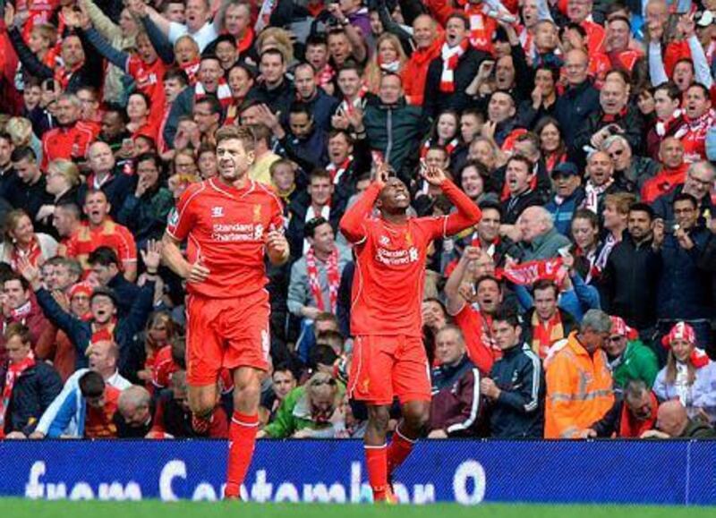 Liverpool's English striker Daniel Sturridge, right, celebrates scoring his team's second goal during the English Premier League football match between Liverpool and Southampton at Anfield stadium in Liverpool, northwest England, on August 17, 2014. AFP PHOTO/PAUL ELLIS

