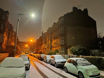 Snow covers the cars and roads in a residential area of Glasgow. PA
