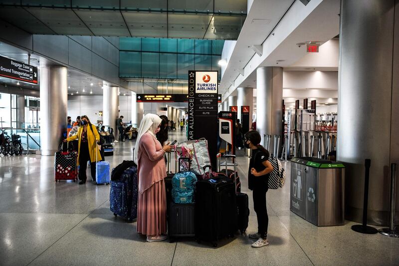 Travellers wait to board flights at Miami International Airport before the long Memorial Day weekend. Global air passenger numbers could rebound from the coronavirus pandemic to top 2019 levels by 2023, the International Air Transport Association predicted on Wednesday. AFP02