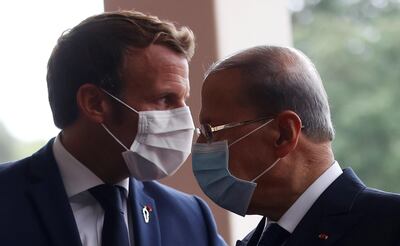 FILE PHOTO: French President Emmanuel Macron and Lebanon's President Michel Aoun wear face masks as they arrives to attend a meeting at the presidential palace in Baabda, Lebanon September 1, 2020. REUTERS/Gonzalo Fuentes/Pool/File Photo