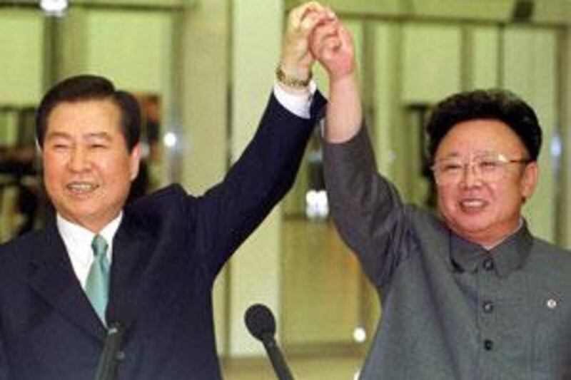 The South Korean president Kim Dae-jung, left, and North Korean leader Kim Jong Il raise their arms together before signing a joint declaration at the end of the second day of a three-day summit in Pyongyang in 2000.
