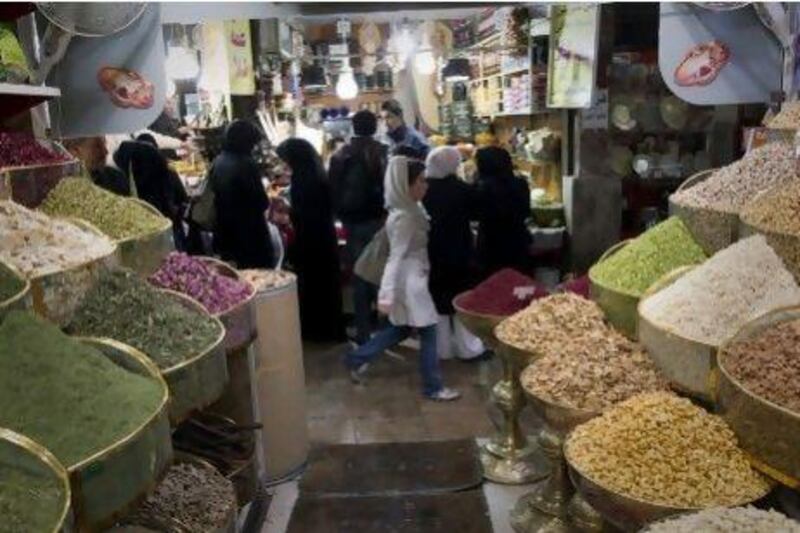 With inflation running around 20 per cent, ordinary Iranians such as these people shopping in Tajrish, north of Tehran, are feeling it in their pockets.