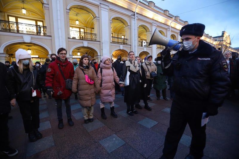 A police officer addresses people gathered to protest against the invasion of Ukraine, in central Saint Petersburg, Russia, February 2022. AFP