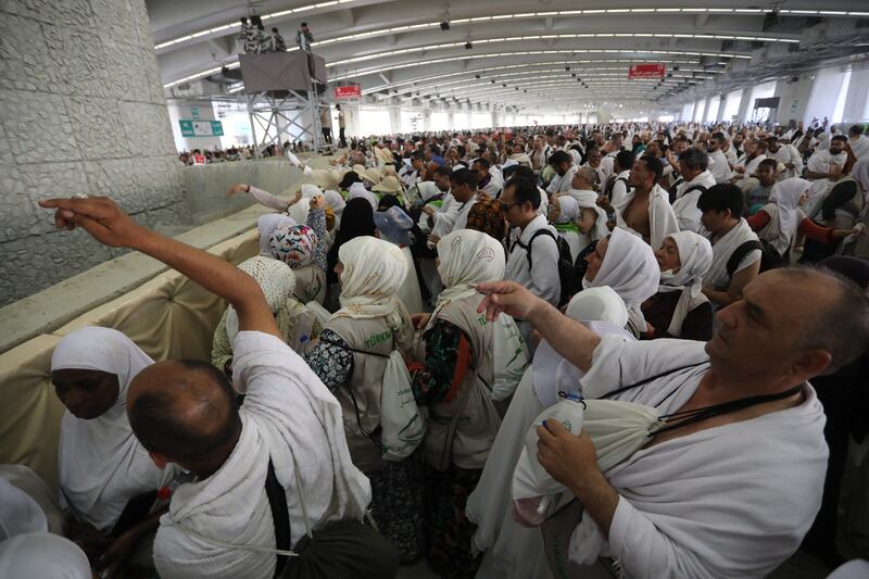 Muslim pilgrims throw pebbles as part of the symbolic stoning of the devil ritual at the Jamarat Bridge during the Hajj pilgrimage near Mecca, Saudi Arabia, 28 June 2023.  Hajj pilgrims took part in the 'stoning of the devil' ritual on the first day of Eid al-Adha during which they throw pebbles at three large pillars.  The Saudi Ministry of Hajj and Umrah announced on 27 June that the number of pilgrims performing this year's Hajj season has reached 1,845,045 from 150 countries.   EPA / ASHRAF AMRA