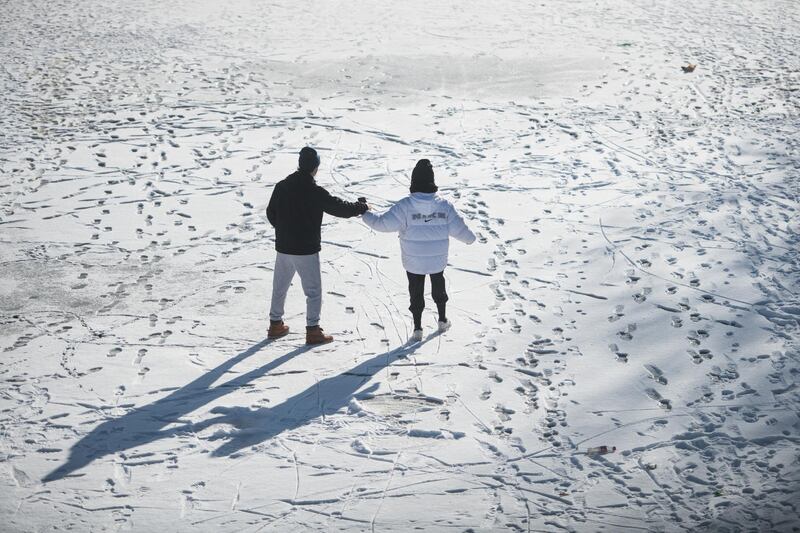 People walk on the frozen Landwehr Canal in Berlin, Germany. Getty