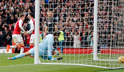 Arsenal's Aaron Ramsey, left, celebrates after scoring his side's second goal during the English Premier League soccer match between Arsenal and Swansea City at the Emirates stadium in London, Saturday, Oct. 28, 2017. (AP Photo/Frank Augstein)