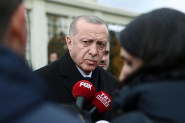 Turkish President Tayyip Erdogan talks to journalists in front of a mosque as he leaves Friday prayers in Istanbul. Presidential Press Office, Handout via Reuters