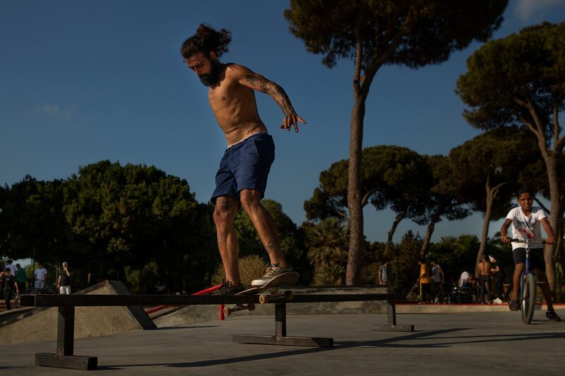 Roberto Nader, 25, performs a boardslide on a rail at the public skatepark.