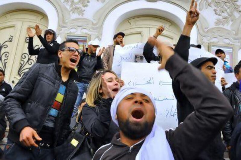 Tunisian protesters demonstrate against their government following the death of an impoverished vendor who torched himself in a street in Tunis.