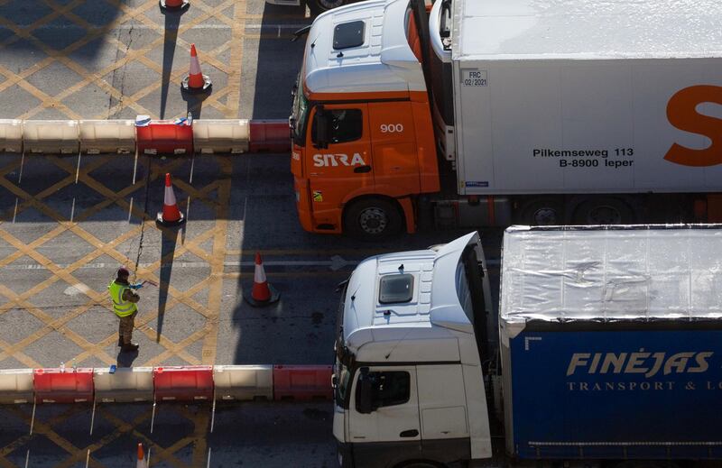 A member of the military checks paperwork for lorries at the entrance to the Port of Dover. Goods are moving smoothly and grocery-store shelves are well stocked. Bloomberg