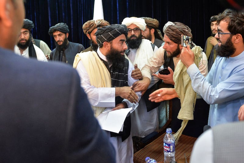 Taliban spokesman Zabihullah Mujahid, centre, holds the group's first press conference in Kabul since the insurgents took the capital. AFP