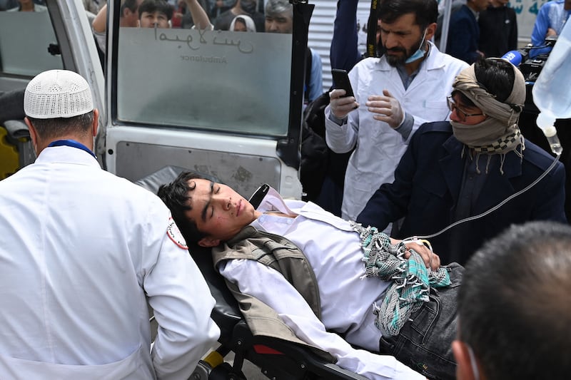 Medical staff move a teenager injured in a bomb attack on boys' school in a Shiite Hazara neighbourhood in Afghanistan's capital Kabul. At least six people were killed. AFP
