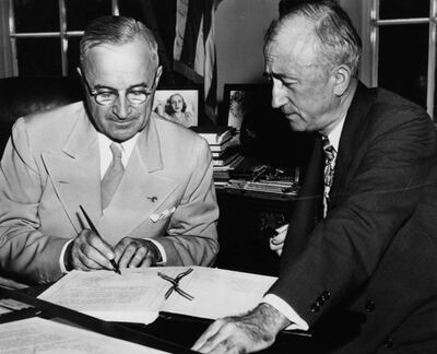 US President Harry S Truman (left) signing the Charter of the United Nations, watched by Secretary of State James F Byrnes, August 8th 1945. (Photo by Fox Photos/Hulton Archive/Getty Images)