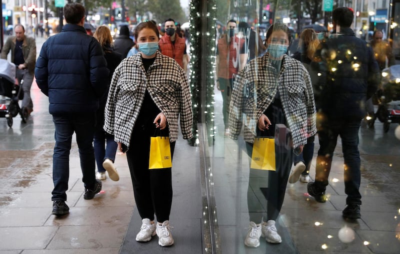 A woman walks past a store on Oxford street in London. Reuters