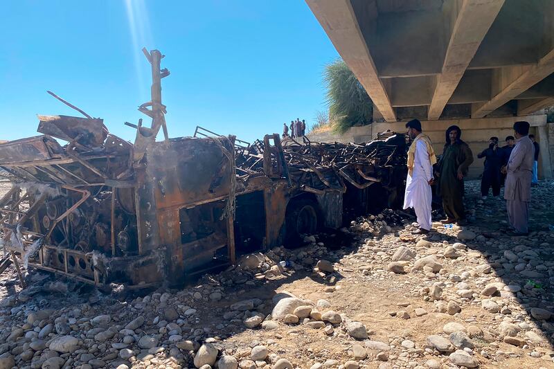 The burnt wreckage of a bus in Bela, in Balochistan province, Pakistan, which fell off a bridge and then caught fire. Dozens were killed. AP Photo
