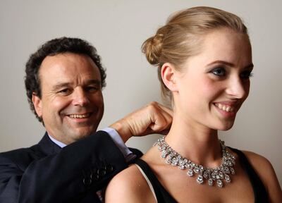 ABU DHABI. 8th October 2008. David Bennett  from Sotheby's adjusts a 1958 diamond necklace on model Alexandra Blacha (19) at the Emirates Palace. The necklace estimated at $1-2 million (US dollars) is part of an exhibition of Sotheby's forthcoming International auctions to be held in London, Geneva and Paris. Stephen Lock /  The National. FOR ARTS & LIFE. *** Local Caption ***  SL-jewellery-007.jpgSL-jewellery-007.jpg