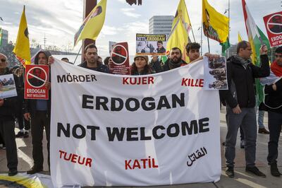epa08076784 Demonstrators hold placards against Turkey's President Erdogan during a Kurds' demonstration in Place des Nations during the United Nations High Commissioner for Refugees (UNHCR) Global Refugee Forum at the European headquarters of the United Nations (UNOG) in Geneva, Switzerland, 17 December 2019.  EPA/SALVATORE DI NOLFI