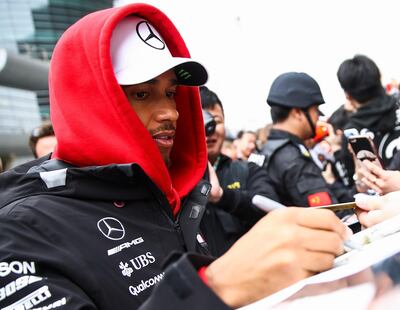 SHANGHAI, CHINA - APRIL 12:  Lewis Hamilton of Great Britain and Mercedes GP signs autographs for fans during the Formula One Grand Prix of China at Shanghai International Circuit on April 12, 2018 in Shanghai, China.  (Photo by Lintao Zhang/Getty Images)