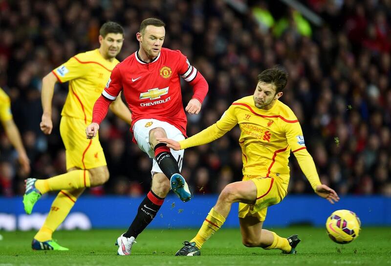 Wayne Rooney of Manchester United plays the ball past Adam Lallana of Liverpool during their Premier League match on Sunday at Old Trafford. Shaun Botterill / Getty Images