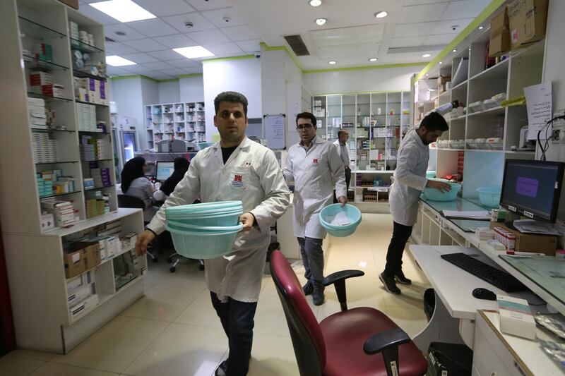 Iranian medical staff work at the state-run pharmacy in Tehran, amid reports of scarce medicine supplies in the country. AFP