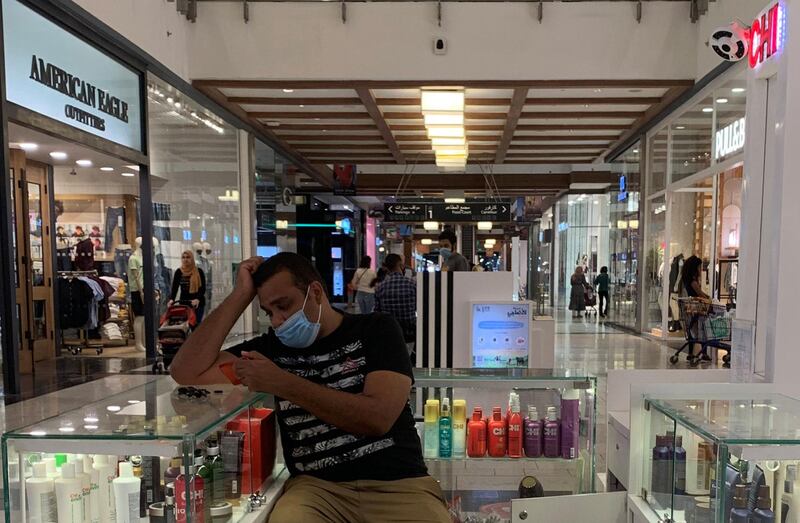 A cosmetics seller wearing a protective face mask amid the coronavirus disease (COVID-19) pandemic waits for shoppers at Mall of Egypt, known as "Mall Masr", owned and operated by the Majid Al Futtaim Group, in the Giza suburb of 6th of October, Egypt. REUTERS