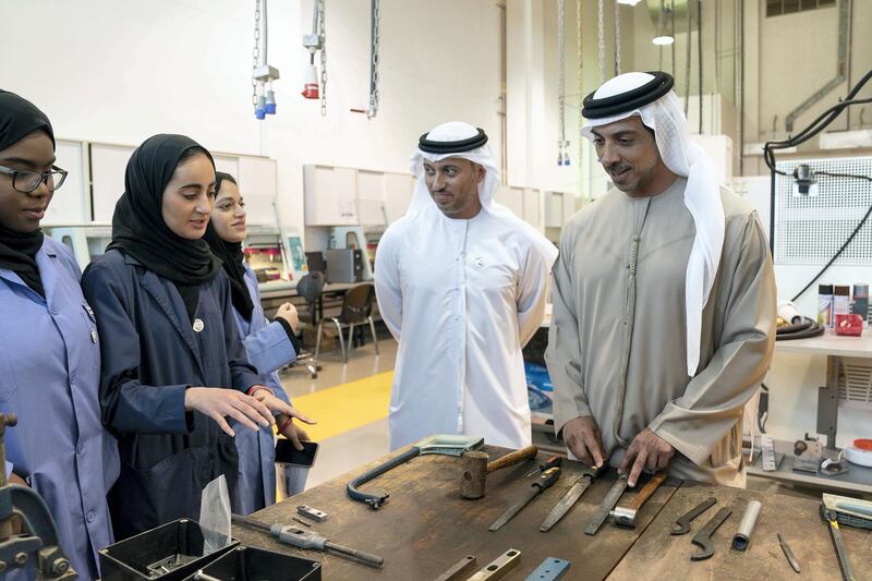 AL AIN, ABU DHABI, UNITED ARAB EMIRATES - February 7, 2019: HH Sheikh Mansour bin Zayed Al Nahyan, UAE Deputy Prime Minister and Minister of Presidential Affairs (R), and HE Dr Ahmed Abdullah Humaid Belhoul Al Falasi, UAE Minister of State for Higher Education (2nd R), speak with students while visiting UAE University in Al Ain. 
( Ryan Carter / Ministry of Presidential Affairs )
---