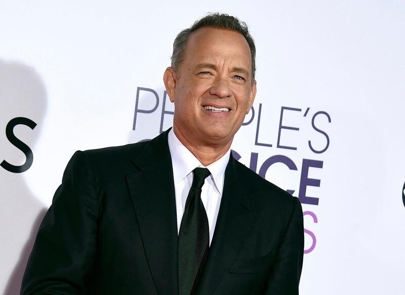 FILE - In this Wednesday, Jan. 18, 2017, file photo, Tom Hanks arrives at the People's Choice Awards at the Microsoft Theater in Los Angeles. Hanks will host a 90-minute primetime TV special celebrating the inauguration of Joe Biden as president of the United States. (Photo by Jordan Strauss/Invision/AP, File)