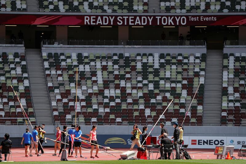 Athletes hold pole vaults at the morning session of the Athletics test event. Reuters