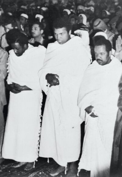 (Original Caption) Flanked by fellow pilgrims, Muhammad Ali, former heavyweight champion of the world, prays inside the Holy Mosque in Mecca recently during his New Year's pilgrimage to the spiritual center of the Moslem world. After visiting Mohammed's tomb in Medina, Ali said that he became convinced that he can defeat Joe Frazier, current heavyweight champ, if they meet in a rematch for the title.
