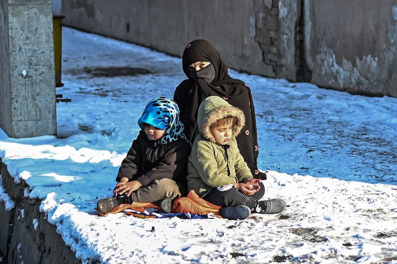 A woman with her children in Kabul on December 16. AFP