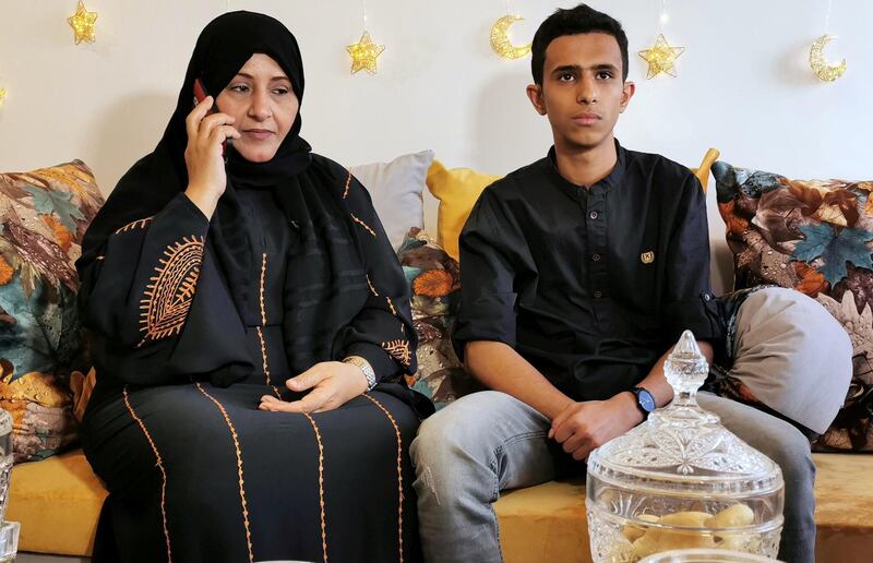 Zafaran Al Muhanna speaks on a mobile phone in Sanaa, Yemen, while she sits with her nephew, as her husband remains stuck in Egypt after flights were grounded. Reuters