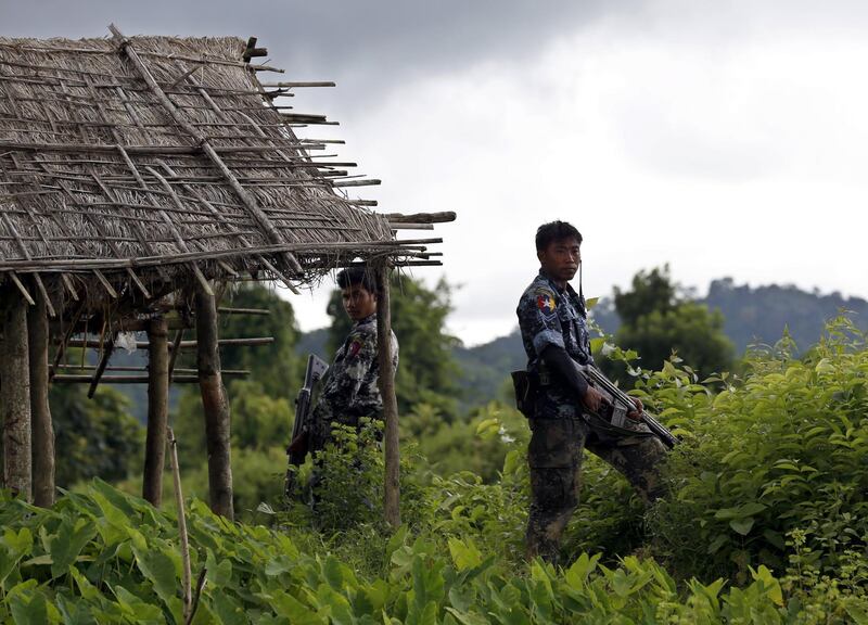 epa06399517 (FILE) - Myanmar police officers stand guard at Yebawkya village of Maungdaw township in Rakhine State, western Myanmar, 27 September 2017 (reissued 20 December 2017). Myanmar said it found 10 bodies buried in a mass grave in a village in northern Rakhine state on 20 December 2017, a day after the military launched an investigation in the area. More than 646,000 Rohingya refugees have crossed the border from Myanmar into Bangladesh, following the Myanmar army's 25 August crackdown on Rohingya rebels in the state of Rakhine.  EPA/NYEIN CHAN NAING