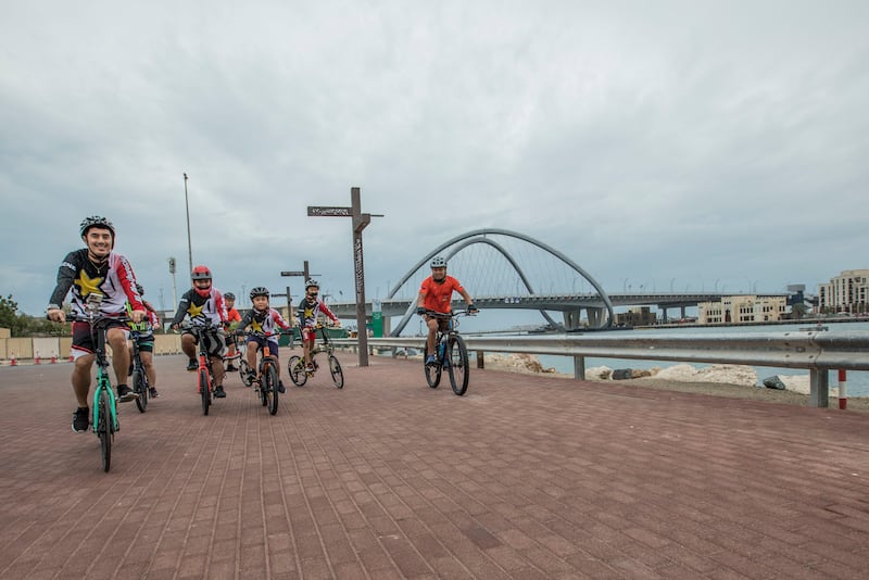 Cyclists brave the weather in Deira. Ruel Pableo for The National