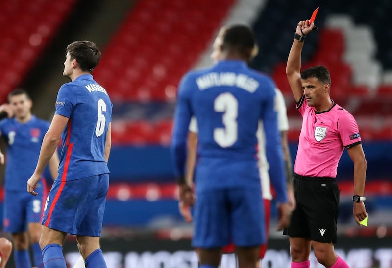 Referee Jesus Gil Manzano shows a red card to England's Harry Maguire. AP
