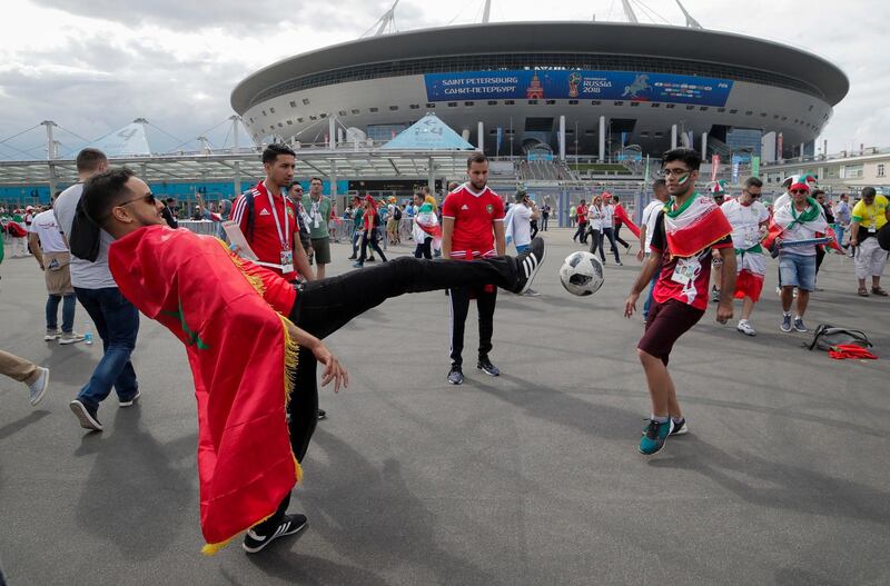 Iranian, right, and Moroccan fans play football in front of Saint Petersburg stadium prior the group B match between Morocco and Iran at the 2018 World Cup in St Petersburg, Russia. Dmitri Lovetsky / AP Photo