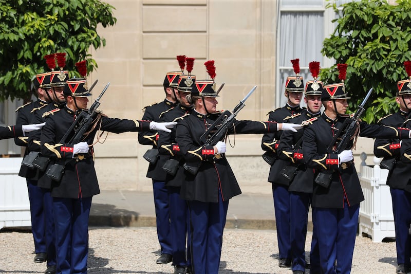 French military personnel line up in the courtyard of the Elysee Palace.