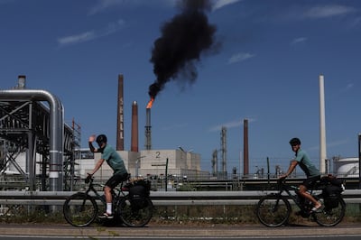 Cyclists pass an industrial park near Cologne belonging to Germany's Germany's powerful chemicals industry. Reuters 