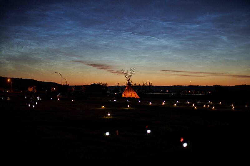 Solar lights and flags now mark the spots where 751 human remains were recently discovered in unmarked graves at the site of the former Marieval Indian Residential School on the Cowessess First Nation in Saskatchewan on June 27, 2021. AFP