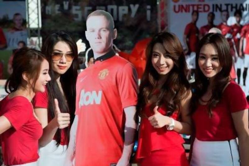 A cardboard cut-out of Wayne Rooney took his place in Thailand yesterday after the Manchester United player returned home.