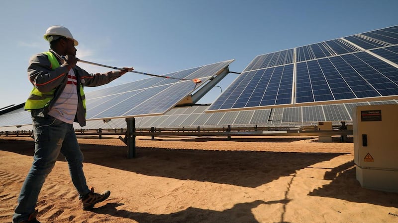 A man cleans panels at the vast Benban Solar Park in Aswan, Egypt. EPA