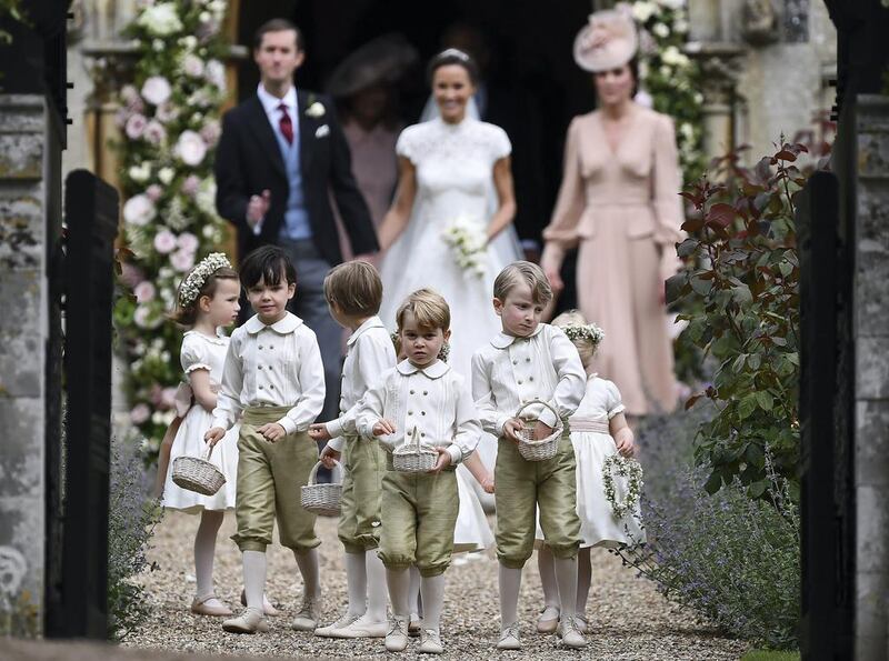 Britain’s Prince George, centre, and other children lead out the bride and groom after the wedding of his aunt, Pippa Middleton, to James Matthews, at St Mark’s Church in Englefield, southern England. Justin Tallis / Pool Photo via AP