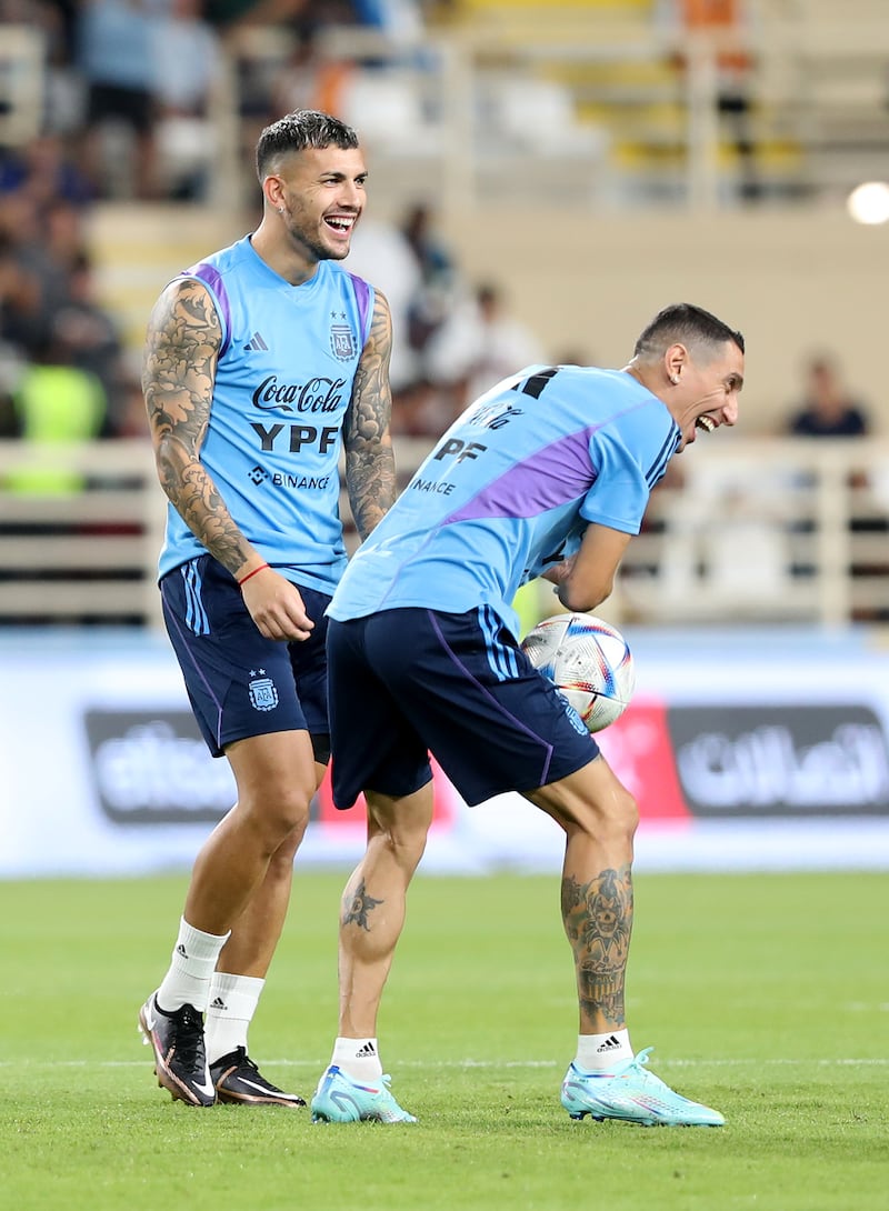 Argentina's Angel Di Maria, right, enjoys a joke with teammate Leo Paredes at Al Nahyan Stadium in Abu Dhabi.