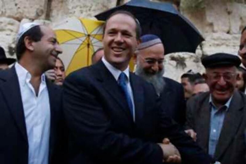 Nir Barkat (2ndL) shakes hands with supporters during a visit to the Western Wall, Judaism's holiest prayer site, in the Old City of Jerusalem November 12, 2008. High-tech entrepreneur Nir Barkat won Israel's mayoral election in Jerusalem on Wednesday, defeating Rabbi Meir Porush in a political battle between the holy city's secular and ultra-Orthodox Jews. REUTERS/Baz Ratner (JERUSALEM) *** Local Caption ***  JER09_ISRAEL-JERUSA_1112_11.JPG