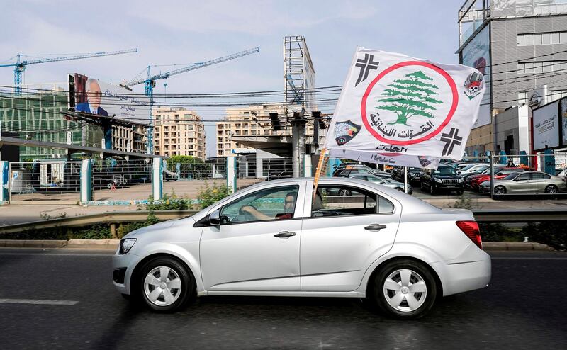 A Lebanese supporter of the Christian Lebanese Forces party drives a car flying their flag along the Dbayeh highway between the coastal city of Jounieh and the capital Beirut. Joseph Eid / AFP