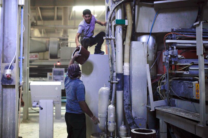 Ras Al Khaimah, June 19, 2013 - Workers change the filters the machines that press tiles at the RAK Ceramics factory in Ras Al Khaimah, June 19, 2013. (Photo by: Sarah Dea/The National)


     This set of photos is for a photo page in Business to run over Ramadan 2013. DO NOT USE BEFORE THEN.