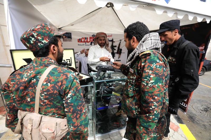 Houthi soldiers visit a weapons booth at a trade fair in Sanaa, Yemen. EPA