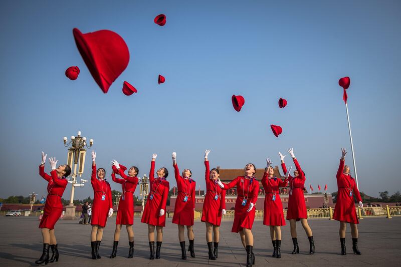 Stewardesses throw their hats up at Tiananmen Square before the closing ceremony of the 19th National Congress of the Communist Party of China (CPC) in Beijing. Roman Pilipey / EPA