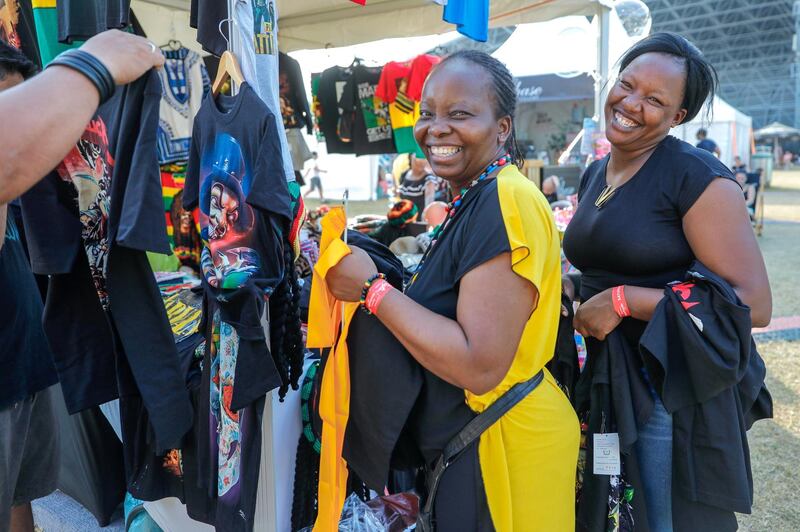 Abu Dhabi, United Arab Emirates, November 9, 2019.  
Taste of Abu Dhabi at the Du Arena.  
-- Happy rock T-shirt vendors arranging the shop.
Victor Besa/The National
Section:  NA
Reporter:  '