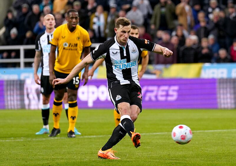 Newcastle United's Chris Wood scores their side's first goal of the game from the penalty spot during the Premier League match at St James' Park. PA.