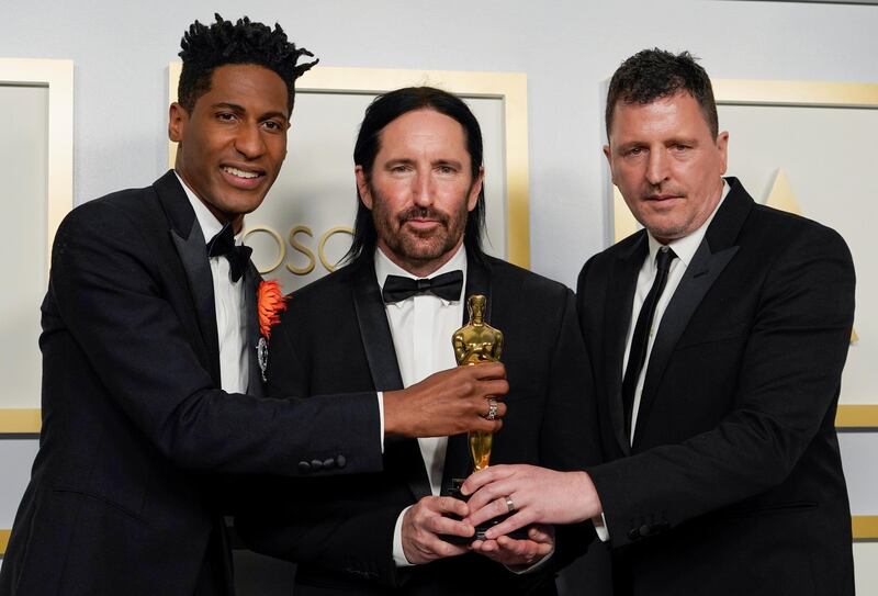 Best Original Score: Jon Batiste, Trent Reznor and Atticus Ross, for 'Soul', pose in the press room at the Oscars on Sunday, April 25, 2021, at Union Station in Los Angeles. Reuters